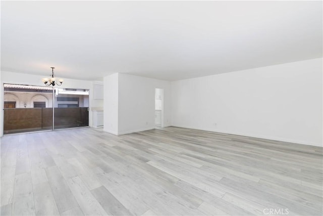 120 S Sierra Madre Blvd Unit 206, Pasadena, CA 91107 - unfurnished living room featuring a chandelier and light wood-style flooring