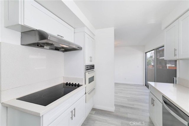 120 S Sierra Madre Blvd Unit 206, Pasadena, CA 91107 - kitchen featuring dishwasher, under cabinet range hood, white oven, black electric cooktop, and a warming drawer