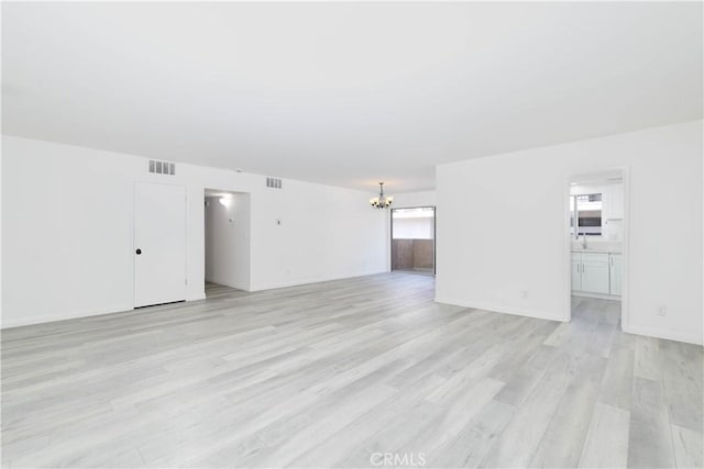 120 S Sierra Madre Blvd Unit 206, Pasadena, CA 91107 - unfurnished living room with a chandelier and light wood-style flooring