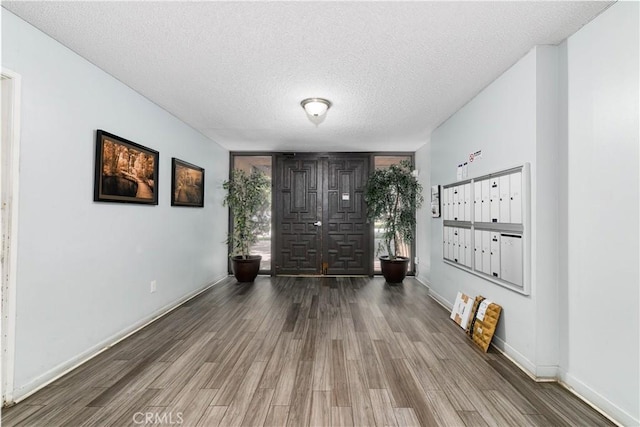 120 S Sierra Madre Blvd Unit 206, Pasadena, CA 91107 - foyer entrance with mail area, wood finished floors, a textured ceiling, and baseboards