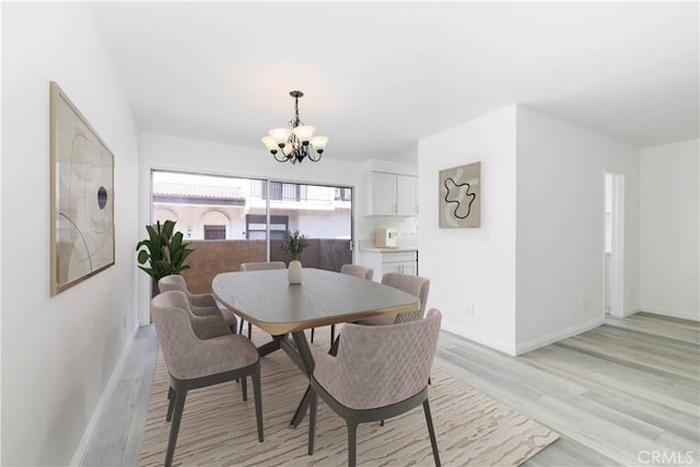 120 S Sierra Madre Blvd Unit 206, Pasadena, CA 91107 - dining space with a chandelier, baseboards, and light wood finished floors