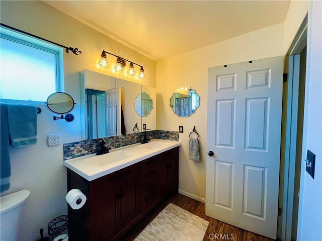 921 Piru Way, Frazier Park, CA 93225 - bathroom with double vanity, wood finished floors, tasteful backsplash, toilet, and baseboards