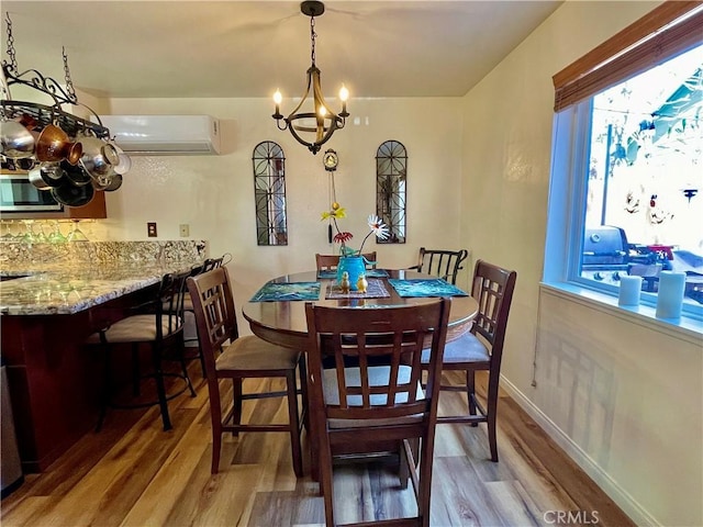 921 Piru Way, Frazier Park, CA 93225 - dining room with light wood-style floors, an AC wall unit, a chandelier, and baseboards
