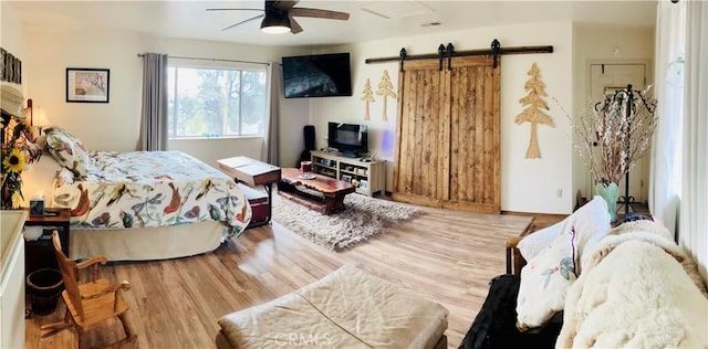 921 Piru Way, Frazier Park, CA 93225 - bedroom with ceiling fan, visible vents, a barn door, and wood finished floors
