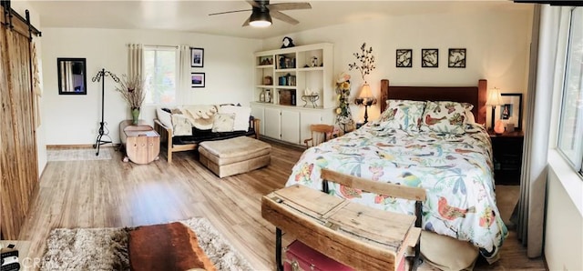 921 Piru Way, Frazier Park, CA 93225 - bedroom featuring wood finished floors, a barn door, and a ceiling fan