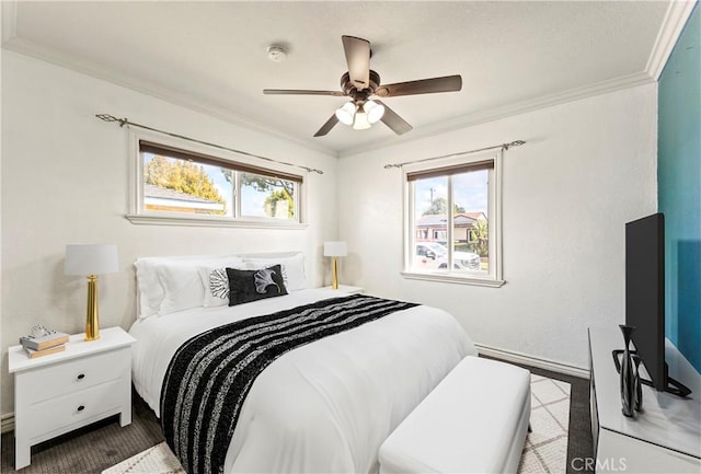 bedroom with crown molding, a ceiling fan, and baseboards