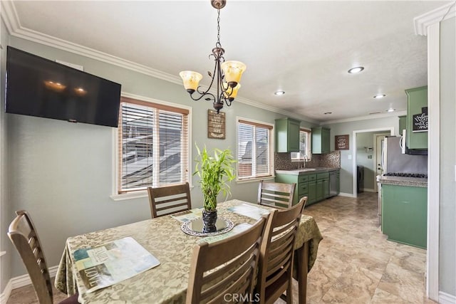 dining space featuring a chandelier, crown molding, recessed lighting, and baseboards