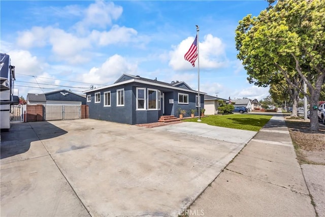 bungalow-style home featuring an outbuilding and stucco siding