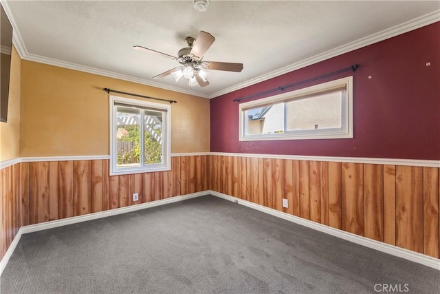 8333 Portulaca Way, Buena Park, CA 90620 - carpeted empty room featuring healthy amount of natural light, wainscoting, ceiling fan, ornamental molding, and wood walls