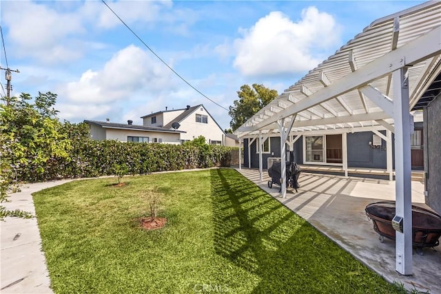 view of yard with a pergola, a patio area, and a fire pit
