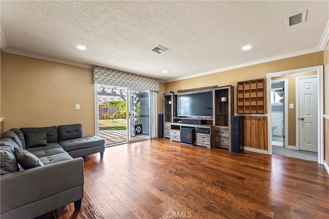 living room with a textured ceiling, dark wood-style flooring, crown molding, and recessed lighting