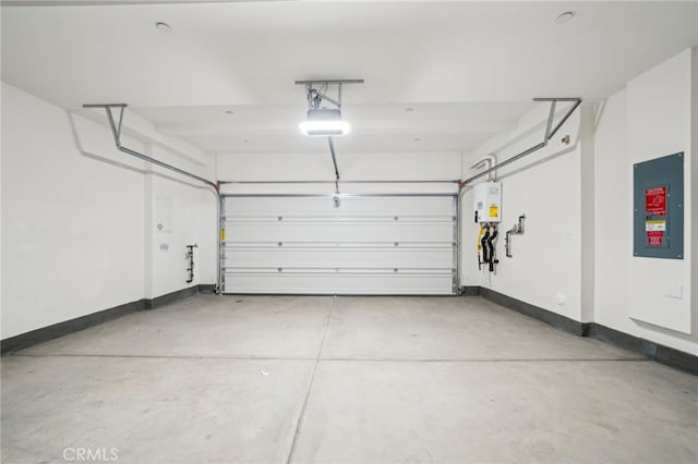 219 Aurora Ln, Pomona, CA 91767 - garage featuring baseboards, tankless water heater, and a garage door opener