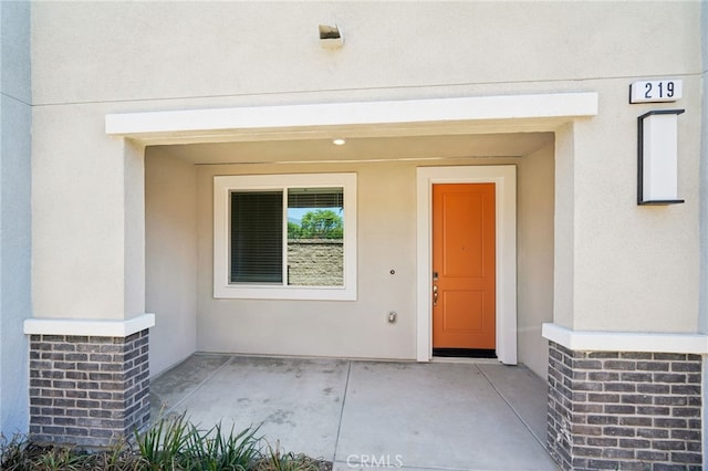 219 Aurora Ln, Pomona, CA 91767 - view of exterior entry with stucco siding and a patio area