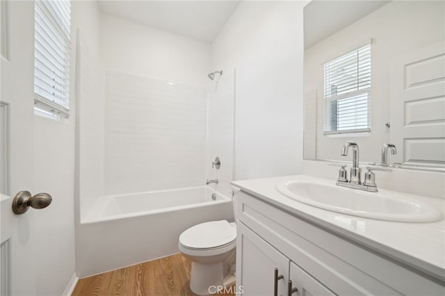 219 Aurora Ln, Pomona, CA 91767 - bathroom featuring toilet, vanity, wood finished floors, and tub / shower combination