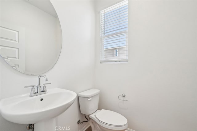 219 Aurora Ln, Pomona, CA 91767 - bathroom featuring baseboards, a sink, and toilet
