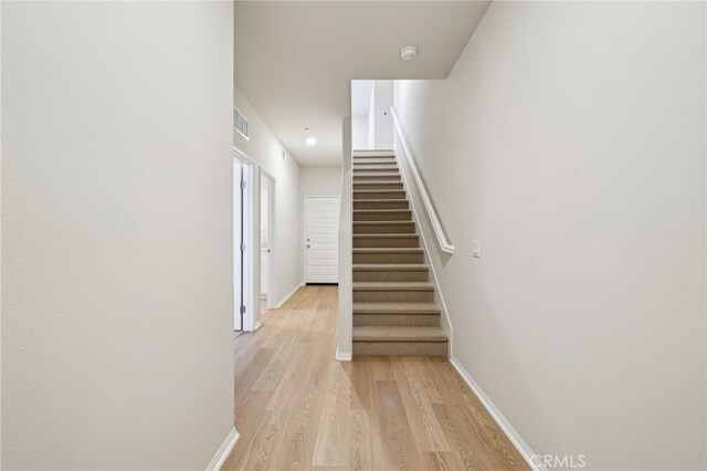 219 Aurora Ln, Pomona, CA 91767 - staircase with wood finished floors and baseboards