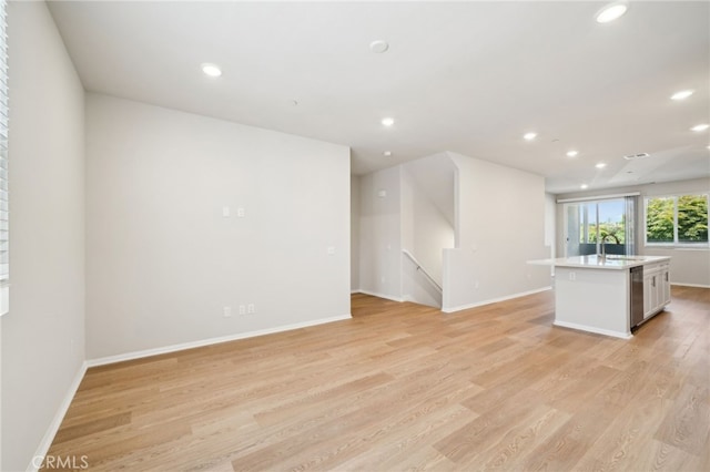 219 Aurora Ln, Pomona, CA 91767 - unfurnished living room featuring light wood-style floors, recessed lighting, and baseboards