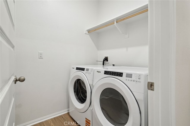 219 Aurora Ln, Pomona, CA 91767 - laundry room with washing machine and clothes dryer, light wood-style flooring, and baseboards