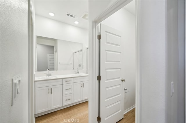 219 Aurora Ln, Pomona, CA 91767 - bathroom featuring wood finished floors and double vanity