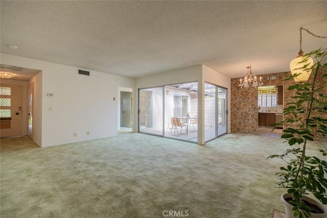 999 E Valley Blvd Unit 44, Alhambra, CA 91801 - unfurnished living room with a chandelier, carpet floors, a textured ceiling, and french doors