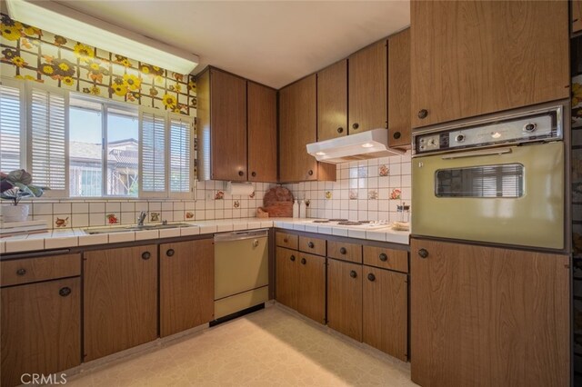 999 E Valley Blvd Unit 44, Alhambra, CA 91801 - kitchen featuring white appliances, under cabinet range hood, a sink, backsplash, and tile counters