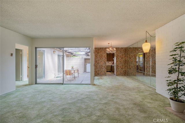 999 E Valley Blvd Unit 44, Alhambra, CA 91801 - unfurnished living room featuring carpet floors, a textured ceiling, and a chandelier