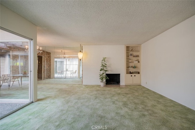 999 E Valley Blvd Unit 44, Alhambra, CA 91801 - unfurnished living room with a chandelier, a large fireplace, carpet, a textured ceiling, and built in features