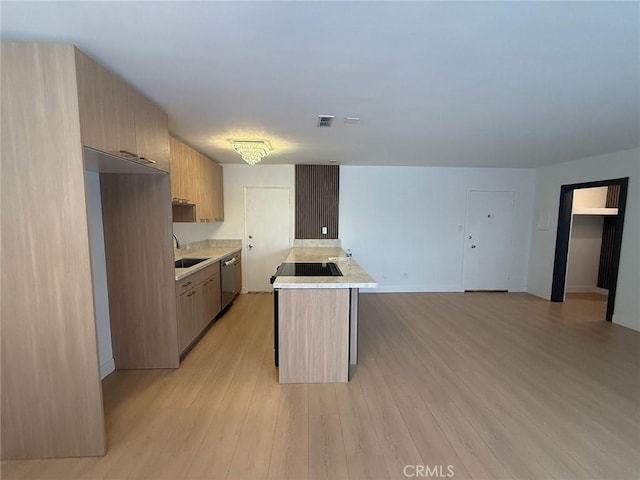 960 Larrabee St Unit 120, West Hollywood, CA 90069 - kitchen featuring dishwasher, light countertops, black stovetop, light wood-style floors, and a sink