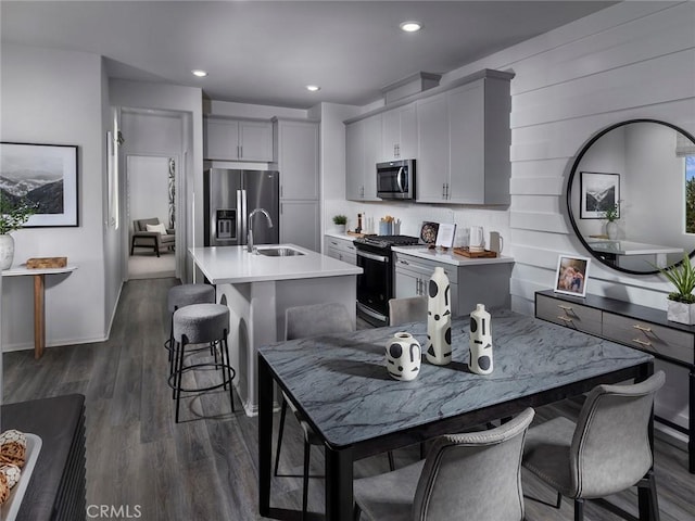 217 Aurora Ln, Pomona, CA 91767 - kitchen featuring stainless steel appliances, a kitchen breakfast bar, a kitchen island with sink, a sink, and light countertops
