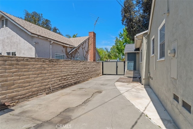 view of patio with fence and a gate