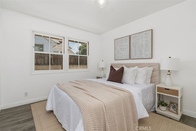 bedroom featuring wood finished floors and baseboards