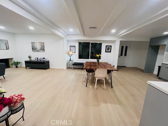 dining space featuring beamed ceiling, recessed lighting, and light wood-type flooring