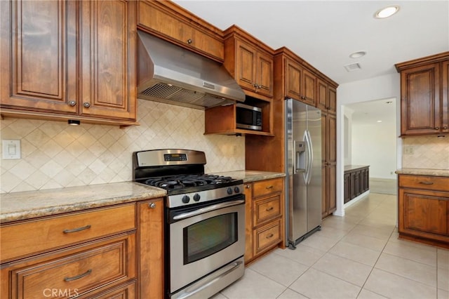 kitchen with appliances with stainless steel finishes, under cabinet range hood, backsplash, light tile patterned flooring, and recessed lighting