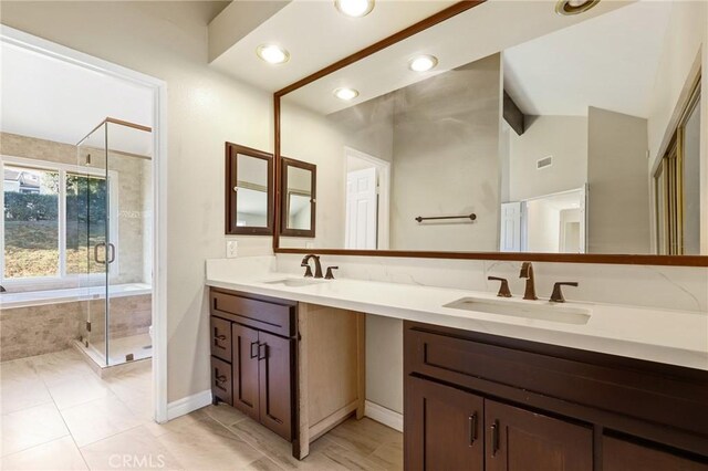 full bath with a stall shower, lofted ceiling, double vanity, a bath, and tile patterned floors