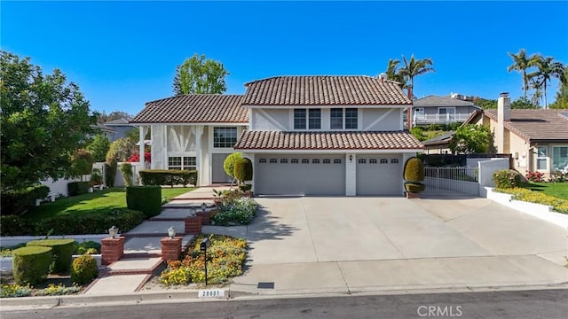 view of front of house featuring a tile roof, driveway, a garage, stucco siding, and fence