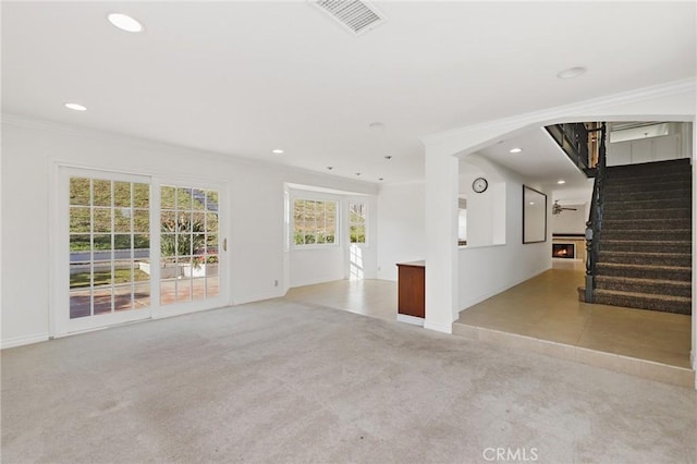 unfurnished living room featuring ornamental molding, light carpet, baseboards, stairs, and recessed lighting