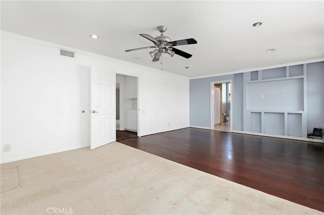 unfurnished living room featuring ceiling fan, ornamental molding, carpet flooring, recessed lighting, and wood finished floors