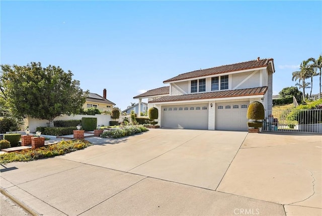 traditional home featuring concrete driveway, stucco siding, and fence