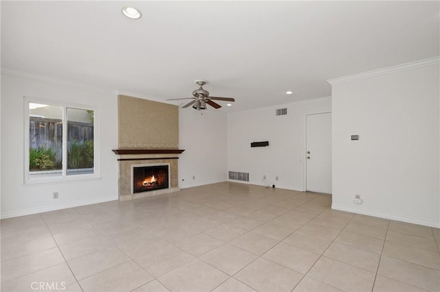 unfurnished living room with a ceiling fan, recessed lighting, crown molding, a large fireplace, and light tile patterned floors