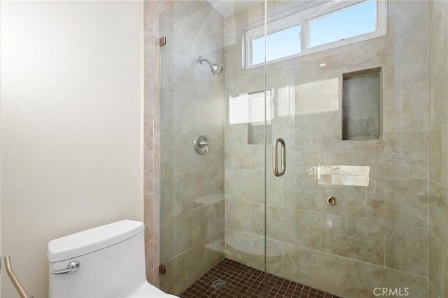full bathroom with a stall shower and toilet