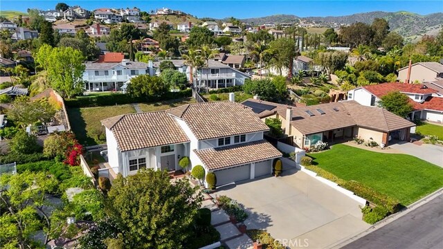 aerial view of residential area featuring a mountain backdrop