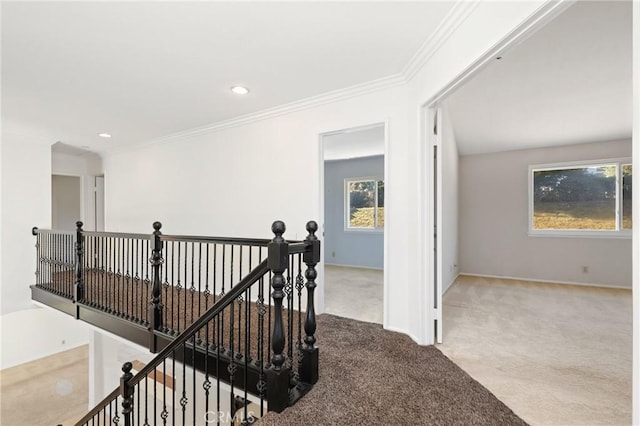 corridor featuring an upstairs landing, carpet flooring, crown molding, recessed lighting, and baseboards