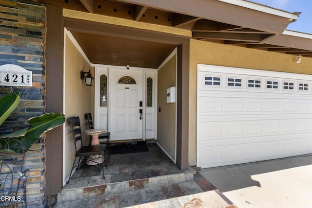 1421 E Abbottson St, Carson, CA 90746 - view of exterior entry with stucco siding and a garage