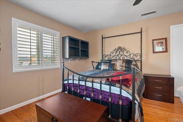 1943 Belmore Ct, El Cajon, CA 92020 - bedroom with visible vents, wood finished floors, baseboards, a textured ceiling, and a ceiling fan