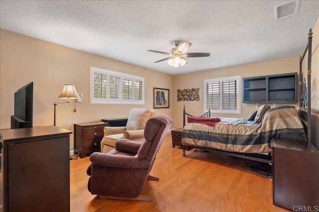 1943 Belmore Ct, El Cajon, CA 92020 - bedroom with a textured ceiling, ceiling fan, wood finished floors, and visible vents