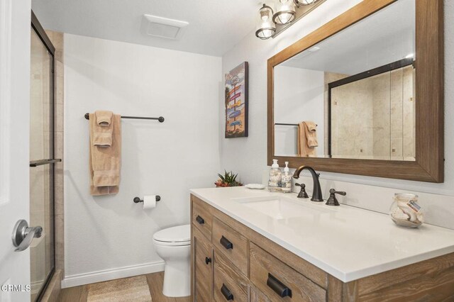 5270 W Wooley Rd, Oxnard, CA 93035 - bathroom with vanity, an enclosed shower, and wood finished floors