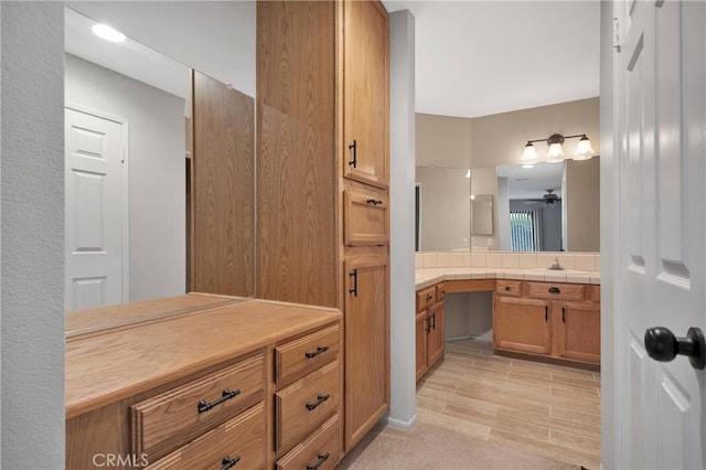 full bath with ceiling fan and vanity
