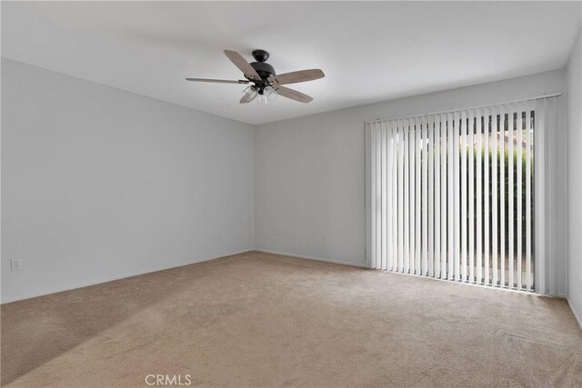unfurnished room with carpet floors and a ceiling fan