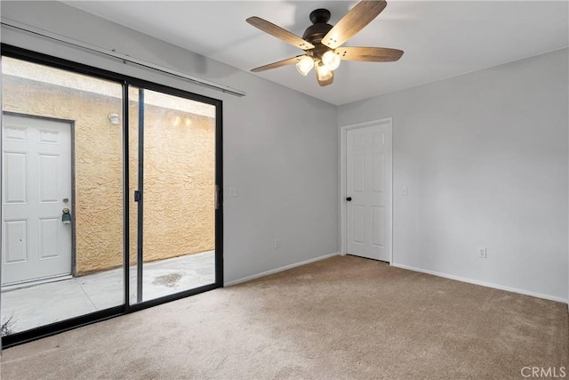 spare room featuring baseboards, a ceiling fan, and carpet flooring