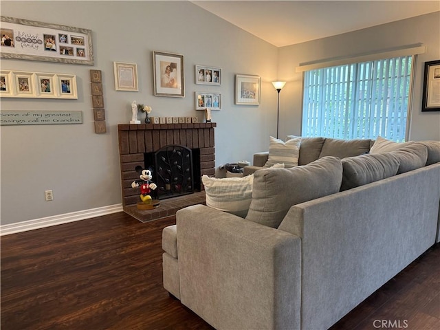 2579 Oak Springs Pl, Ontario, CA 91761 - living area with dark wood finished floors, baseboards, vaulted ceiling, and a brick fireplace